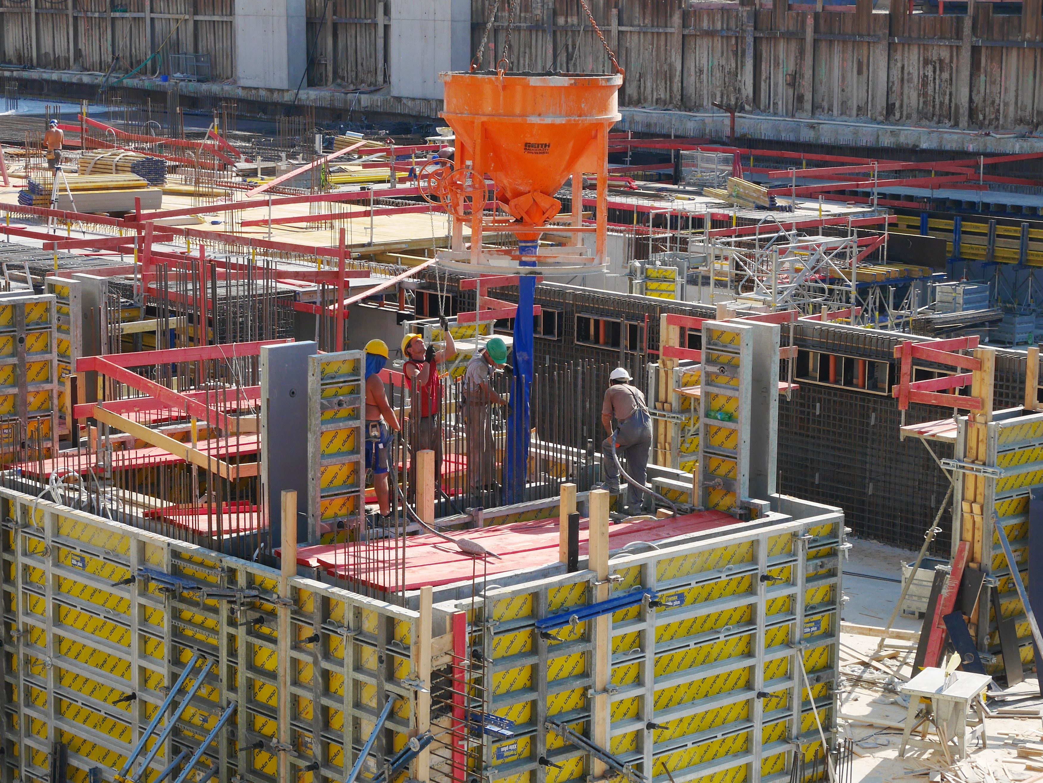 Multi-storey steel-framed commercial building under construction with scaffolding
